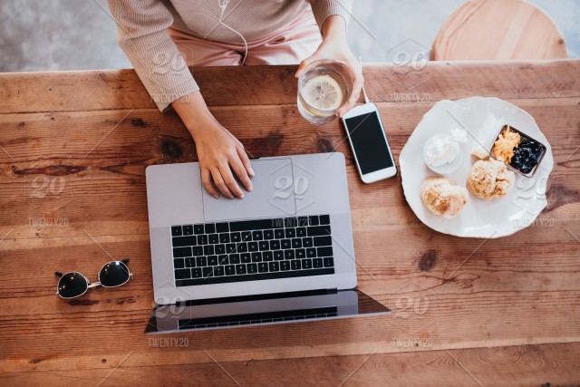 stock-photo-food-business-cafe-woman-laptop-phone-work-desk-top-view-95b8ae47-f47d-45d0-80a1-64aa936dfbef