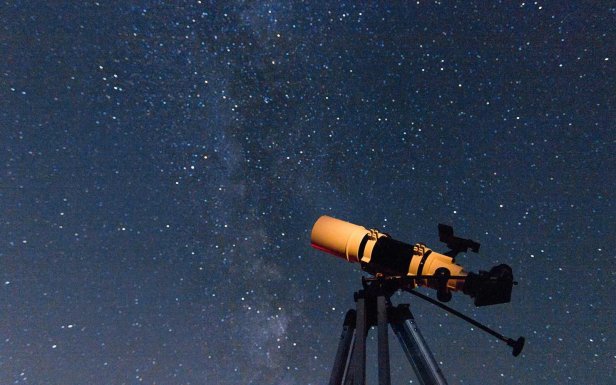 Telescope in real night sky. Refractor type. telescope