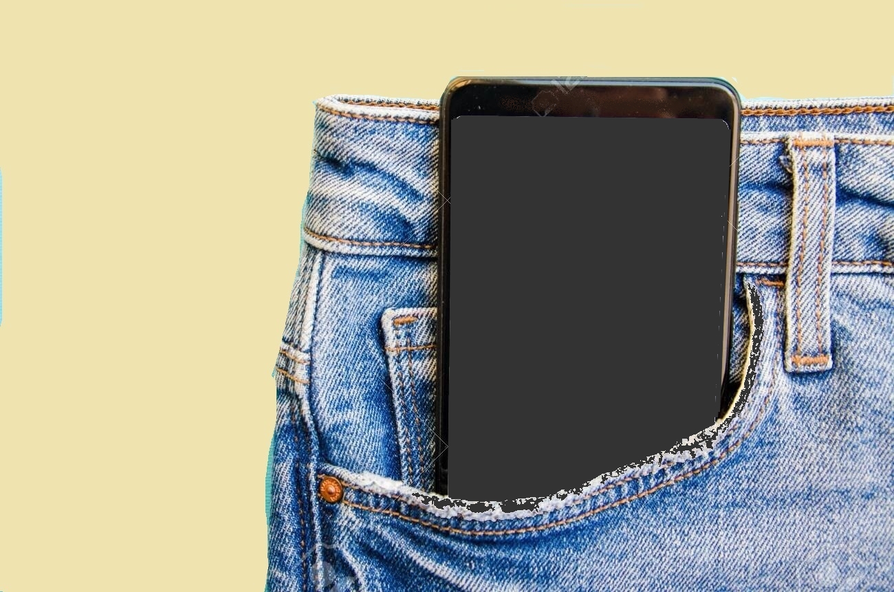 White screen smartphone in jeans pocket. Smartphone place for text. Smartphone in a pocket on a blue background.  Copy Space