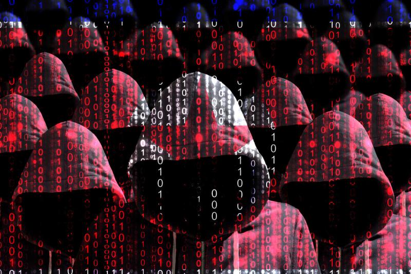 Group of hooded hackers shining through a digital north korean flag