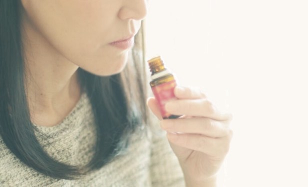 Woman smelling the essential oil